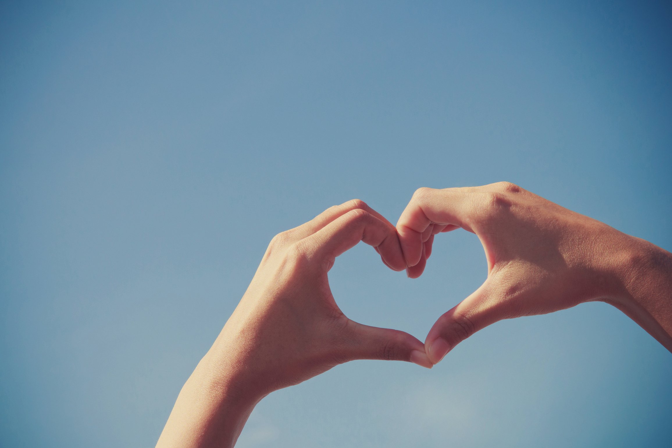 Girl hand heart shape love blue sky
